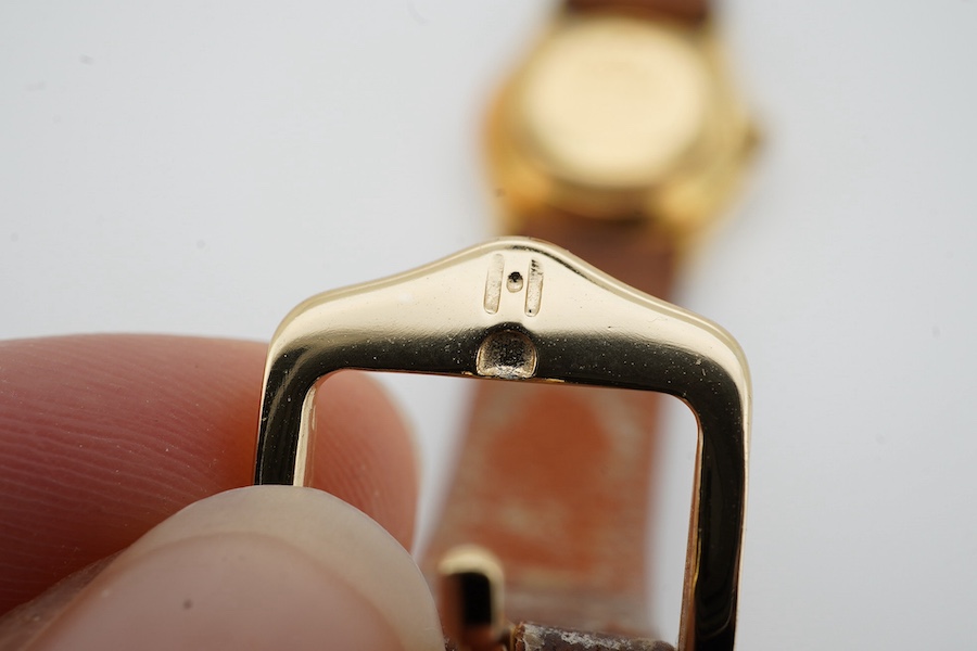 A lady's 18k Jaeger LeCoultre automatic wrist watch, with baton numerals, case diameter 24mm, on a later associated leather strap. Condition - fair